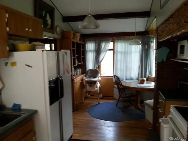 a room with wooden floor and furniture