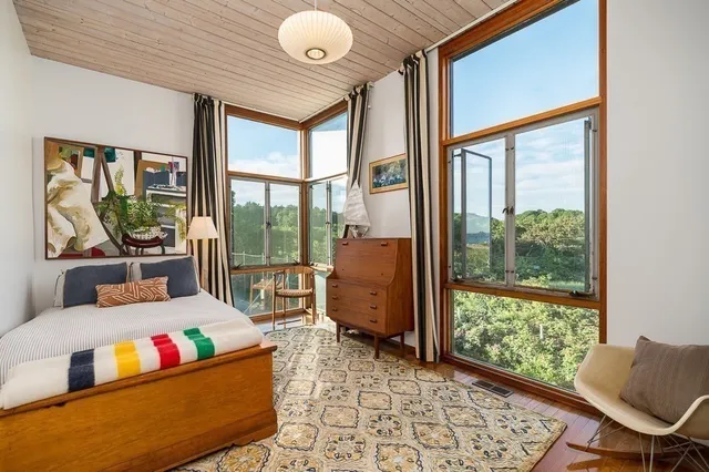 a living room with furniture and a floor to ceiling window