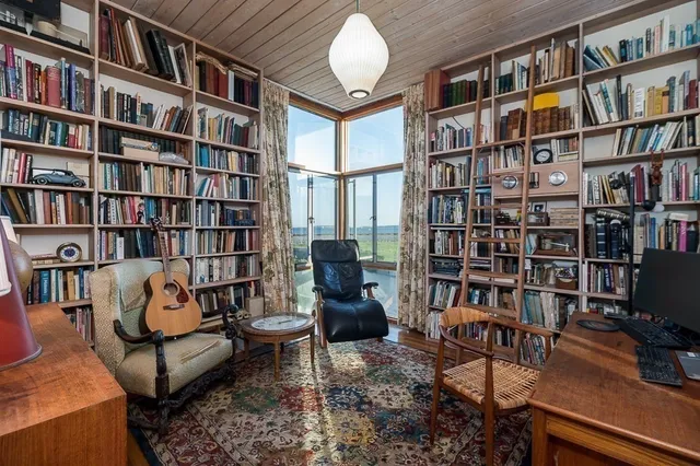 a living room with large lots of books