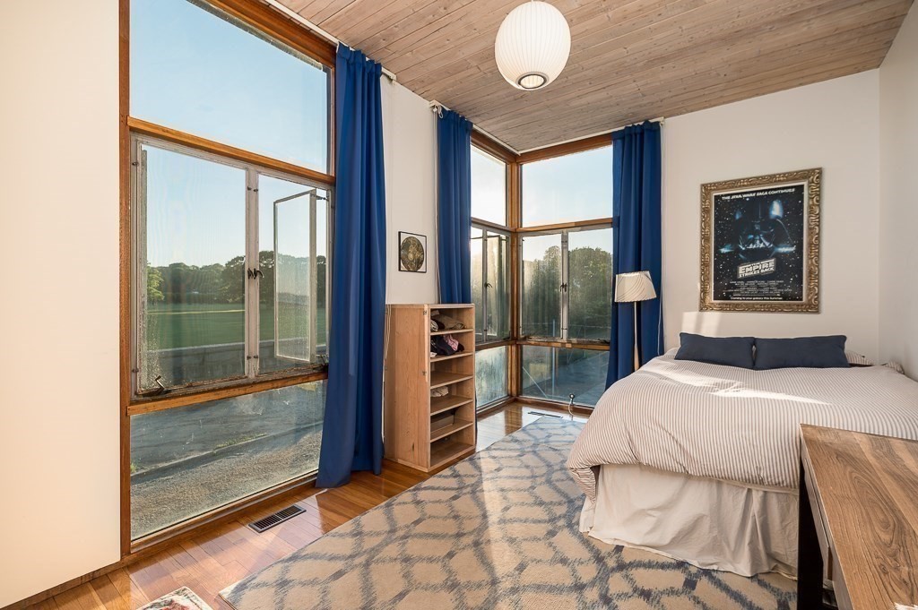 68 Paine Avenue Beverly, MA 01915 - Photo 21 of 32 a bedroom with a large bed and a large window with balcony view