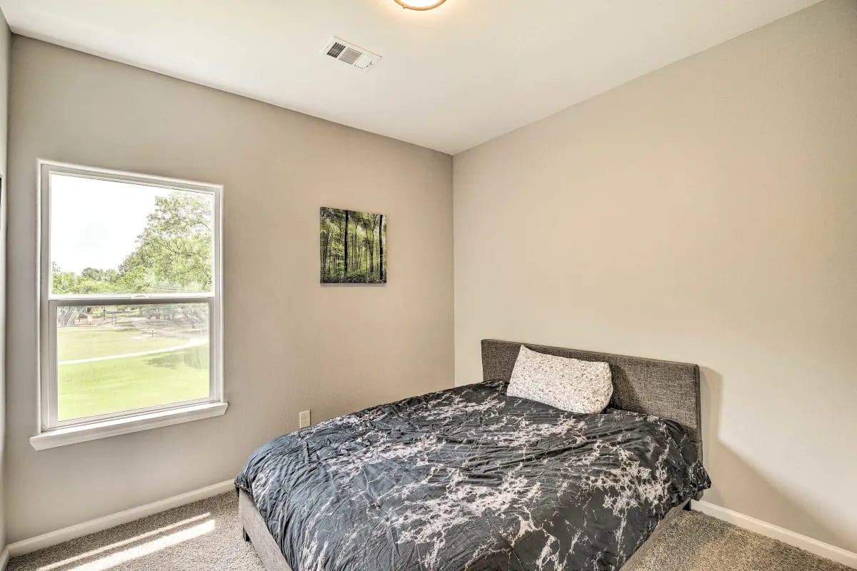 4909 Sunflower Street Houston, TX 77033 - Photo 13 of 25 a bedroom with a bed and a window