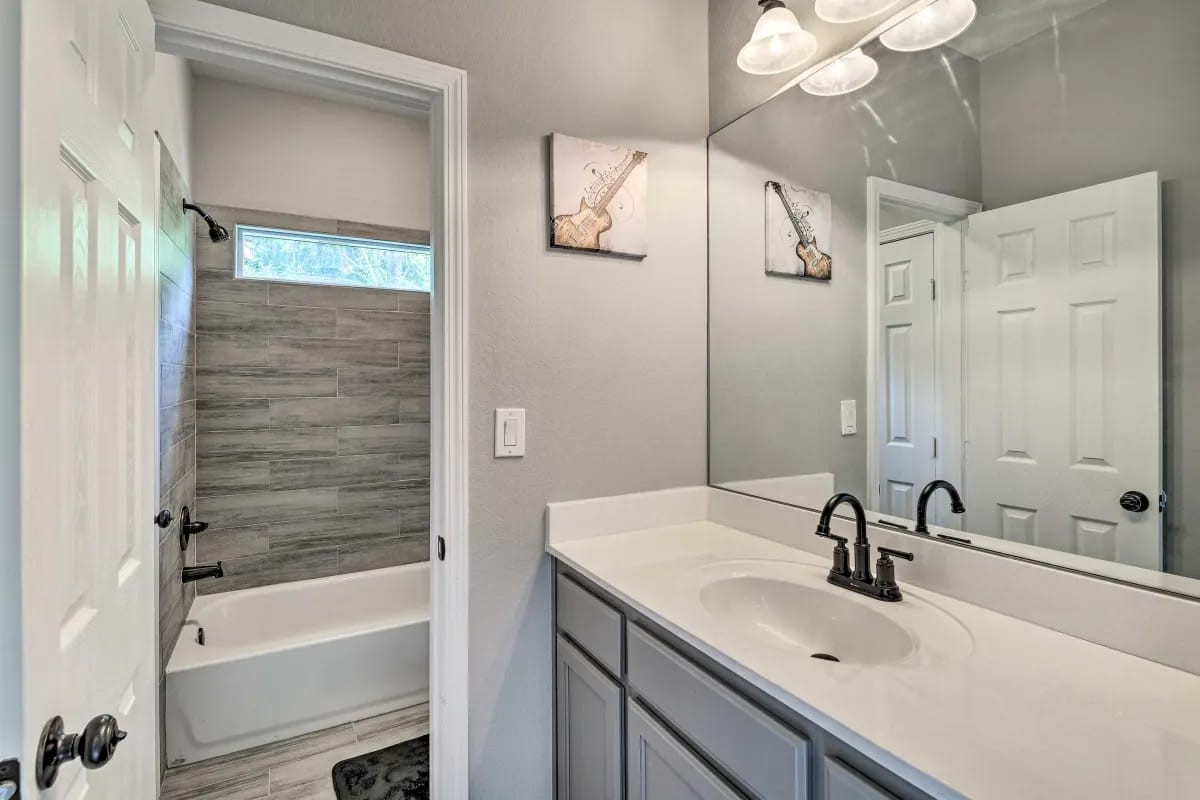 4909 Sunflower Street Houston, TX 77033 - Photo 17 of 25 a bathroom with a sink and a mirror