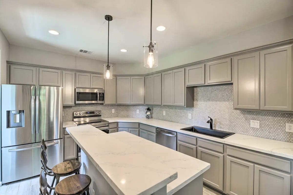 4909 Sunflower Street Houston, TX 77033 - Photo 3 of 25 a kitchen with kitchen island a sink appliances and cabinets
