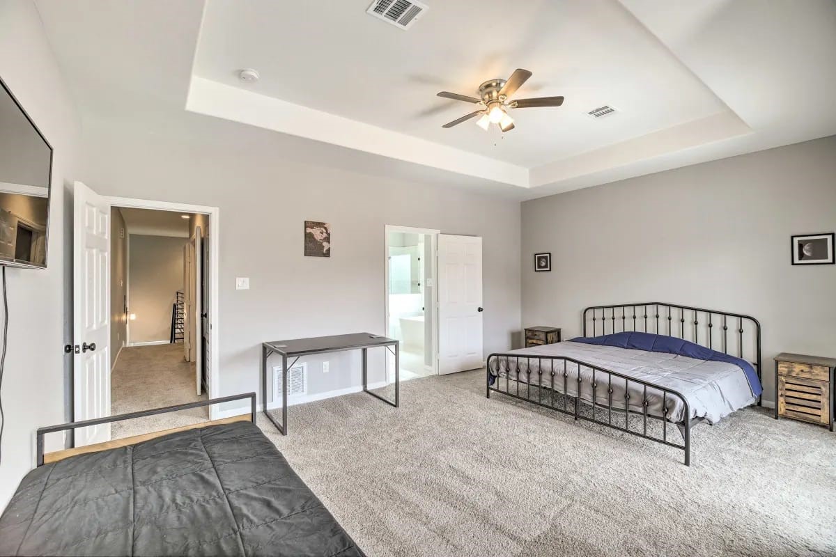 4909 Sunflower Street Houston, TX 77033 - Photo 10 of 25 a spacious bedroom with a bed and ceiling fan