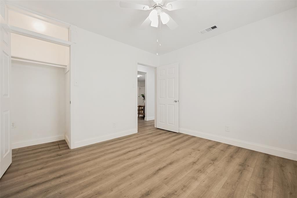 2316 Cunningham Street Irving, TX 75062 - Photo 16 of 22 Room featuring wood-finish flooring, white baseboards, and a white ceiling fan with light fixture