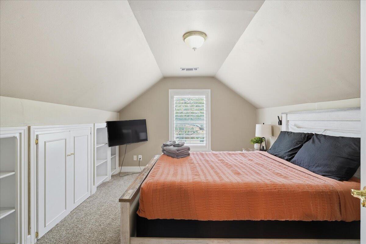 2702 20th Street Lubbock, TX 79410 - Photo 23 of 34 a bedroom with a bed and a tv