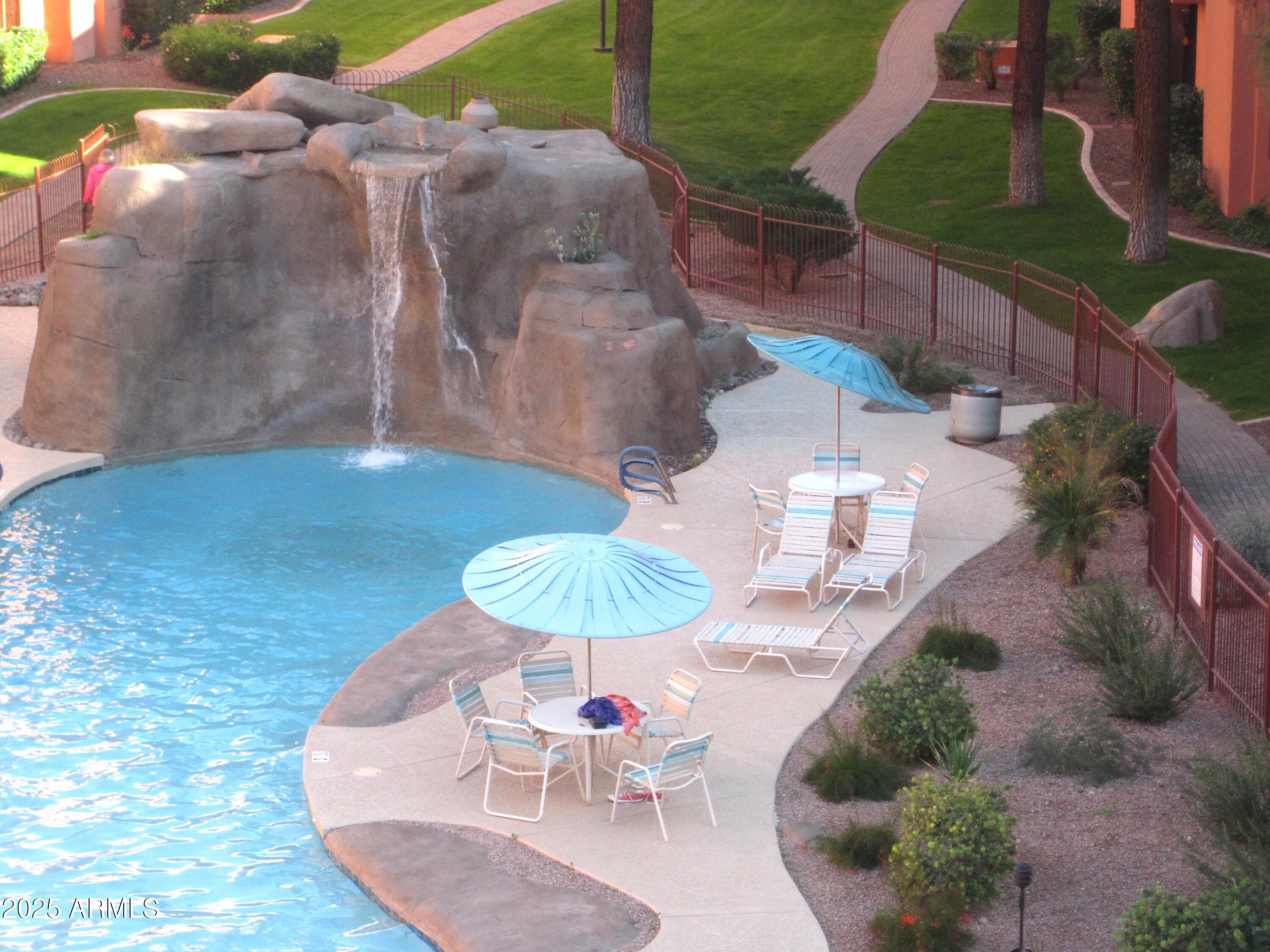 a backyard of a house with a yard and outdoor seating