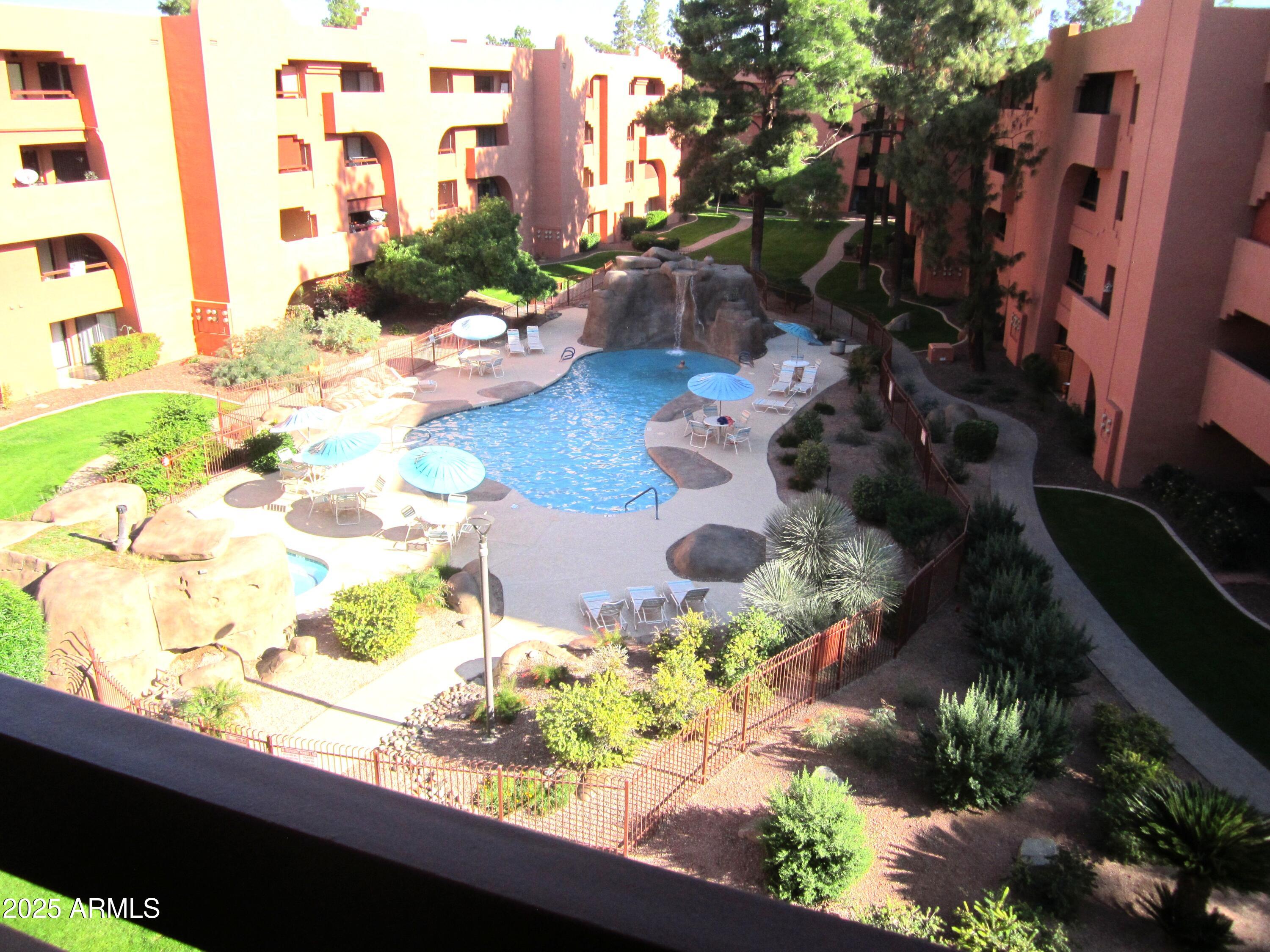 4303 East Cactus Road, Unit 407 Phoenix, AZ 85032 - Photo 12 of 16 a floor to ceiling window with wooden floor