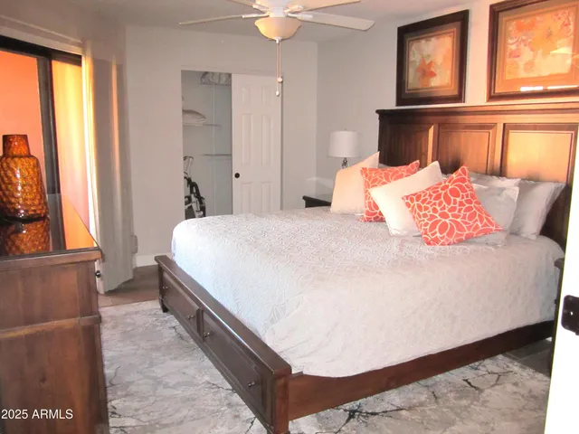 a bedroom with a bed and a window