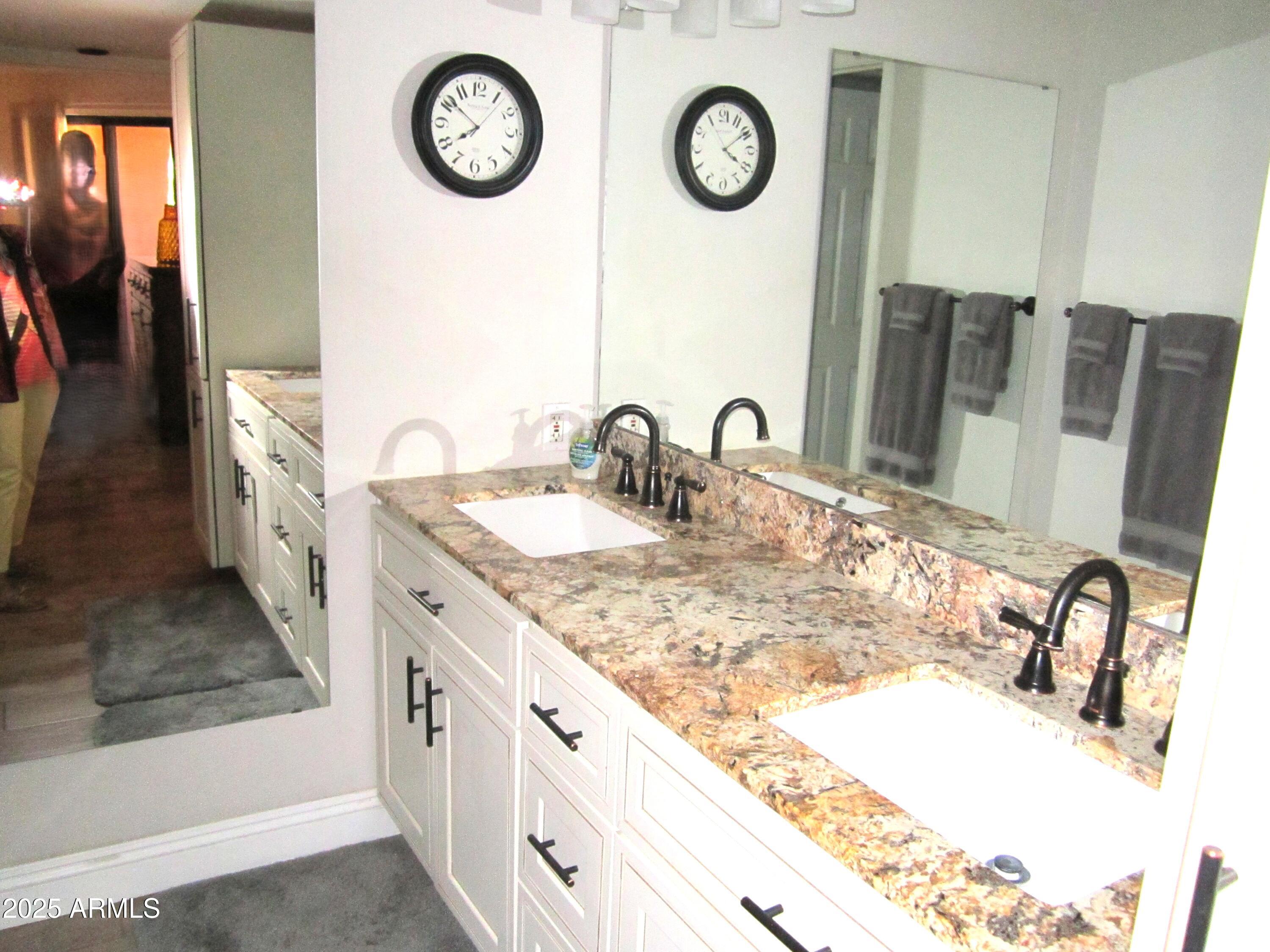 4303 East Cactus Road, Unit 407 Phoenix, AZ 85032 - Photo 8 of 16 a bathroom with a sink and a mirror