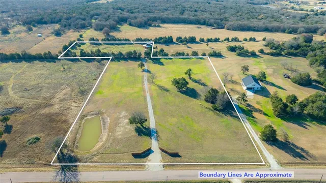 an aerial view of residential houses with outdoor space and lake view