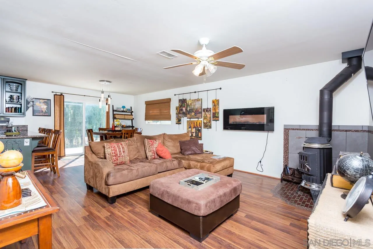 2341 Lake Morena Drive Campo, CA 91906 - Photo 28 of 45 a living room with furniture a flat screen tv and a table