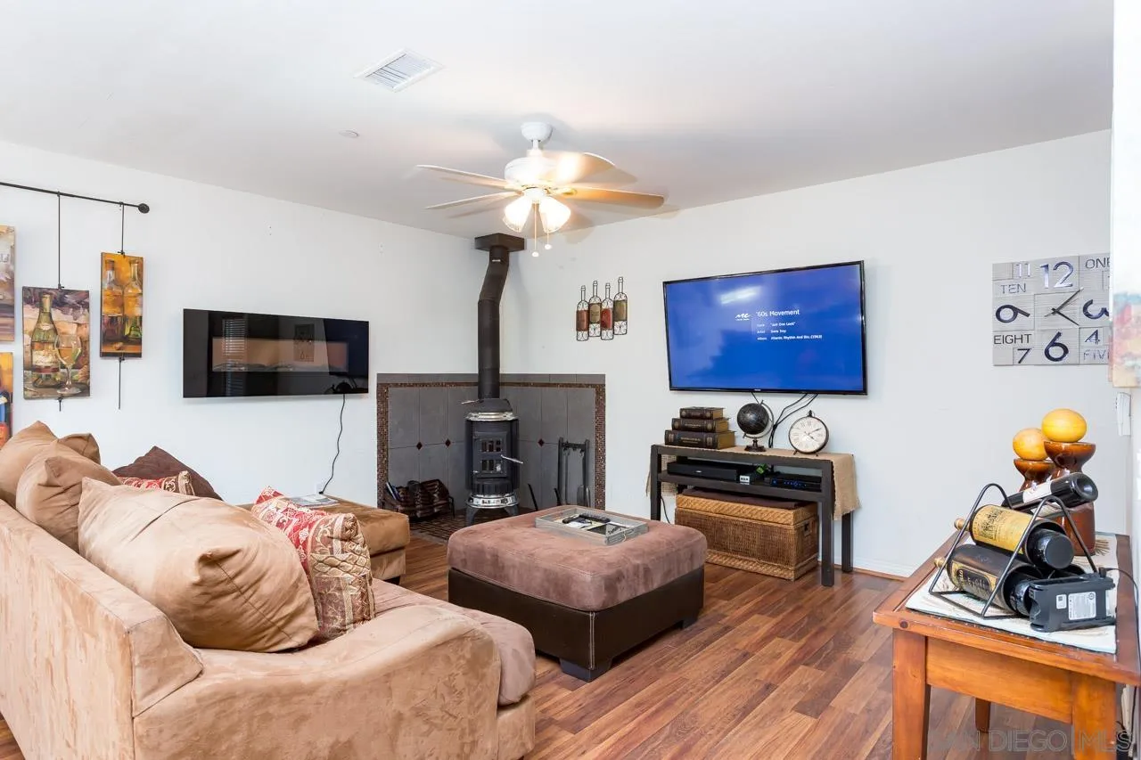 2341 Lake Morena Drive Campo, CA 91906 - Photo 29 of 45 a living room with furniture a flat screen tv and kitchen view