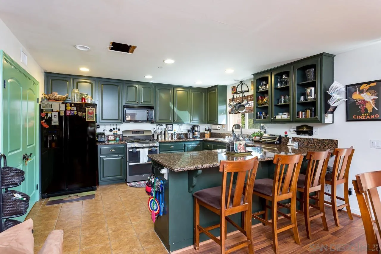 2341 Lake Morena Drive Campo, CA 91906 - Photo 36 of 45 a dining table with chairs and kitchen view