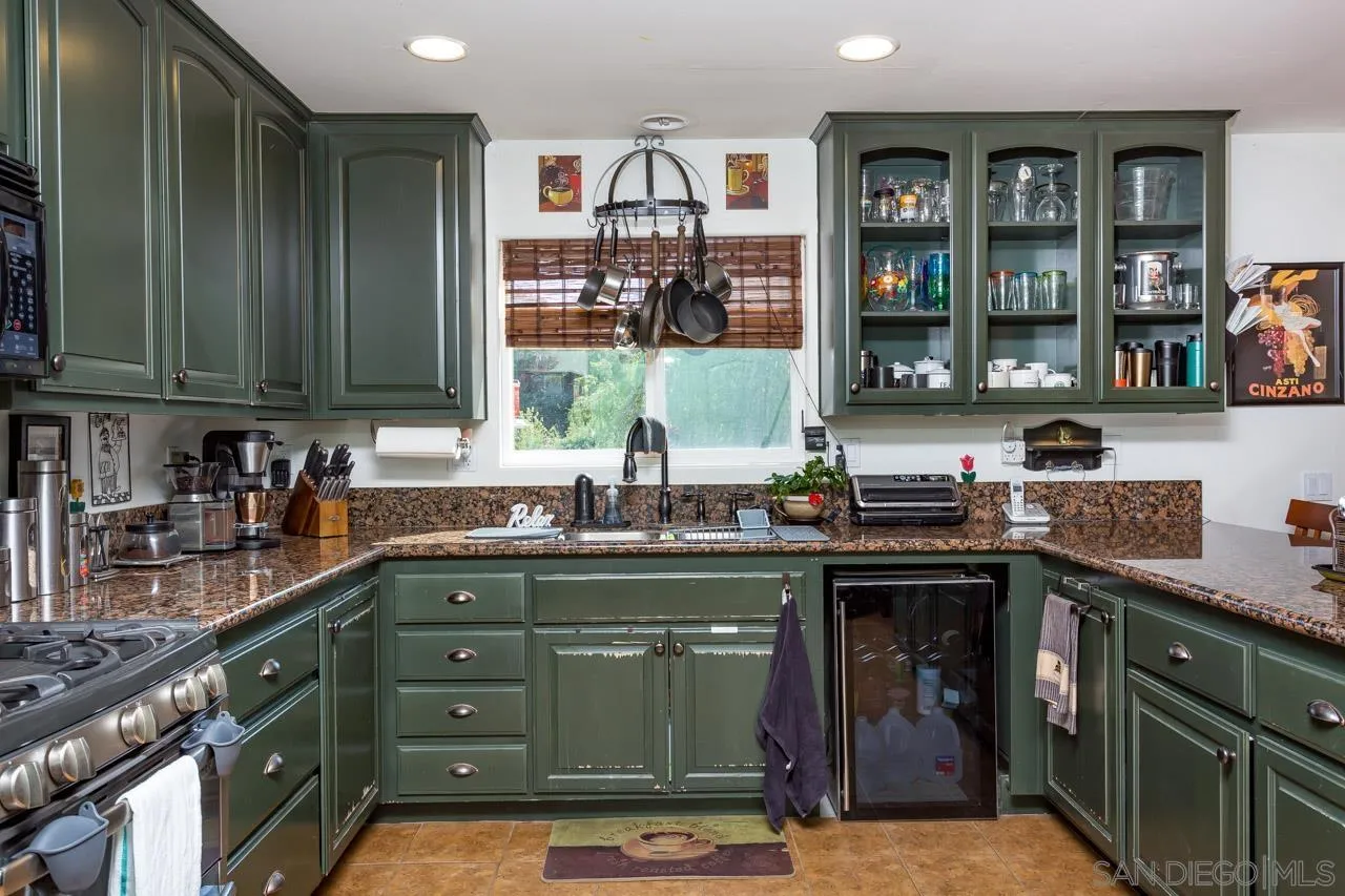 2341 Lake Morena Drive Campo, CA 91906 - Photo 38 of 45 a kitchen with stainless steel appliances granite countertop a stove and cabinets
