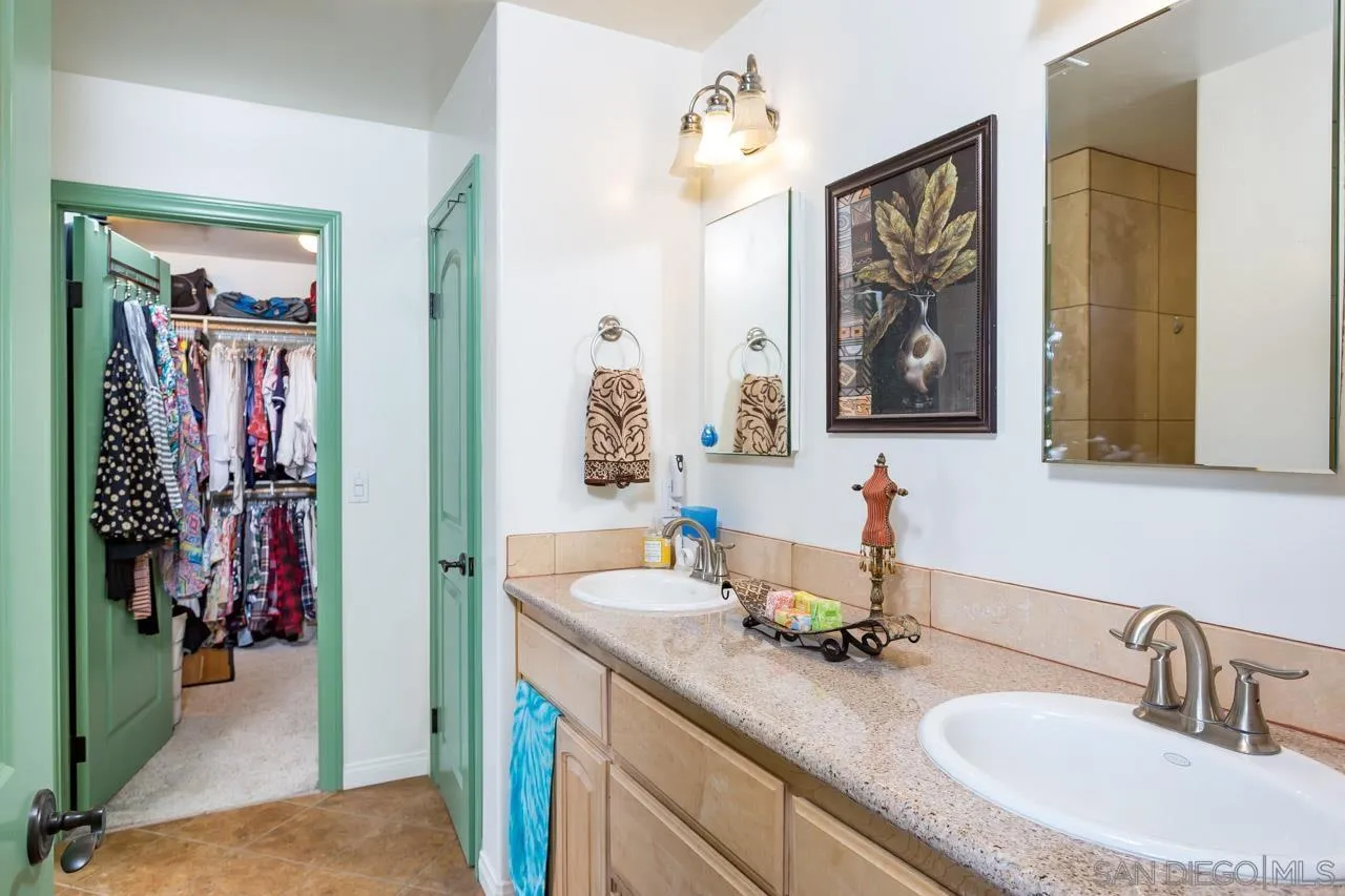 2341 Lake Morena Drive Campo, CA 91906 - Photo 6 of 45 a bathroom with double vanity sinks a vanity and a mirror