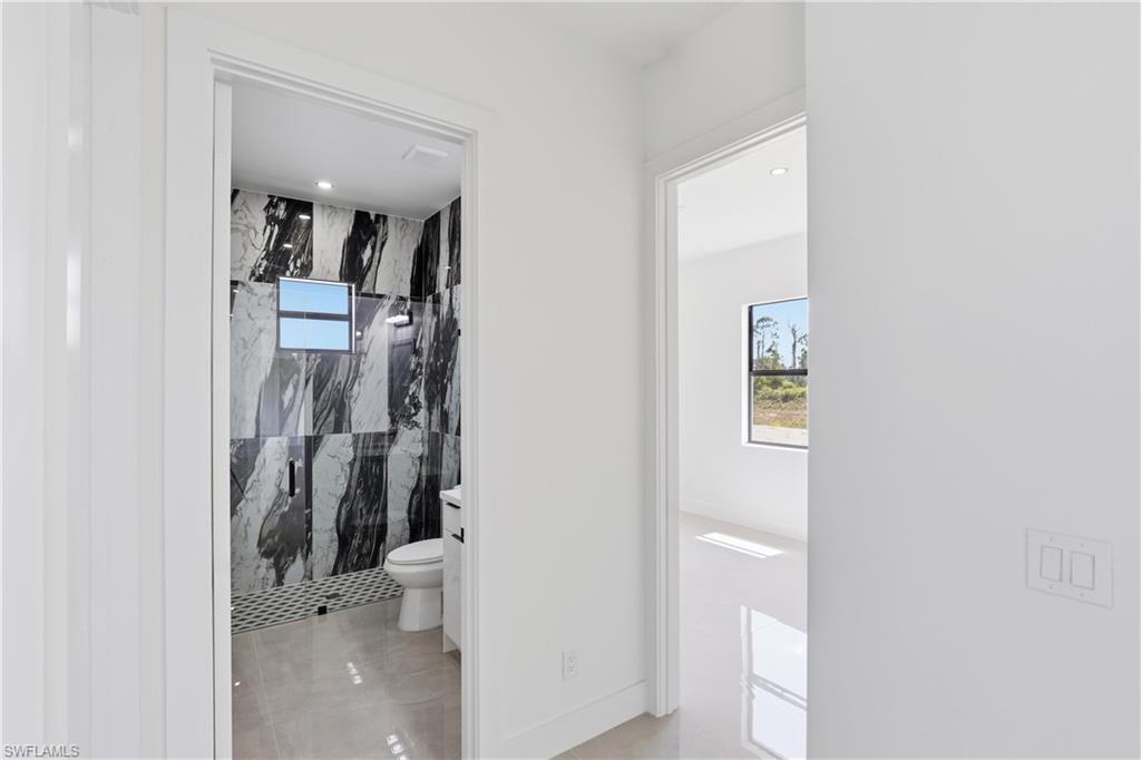 1122 Edelweiss Street East Lehigh Acres, FL 33974 - Photo 15 of 27 a bathroom with a toilet and a shower