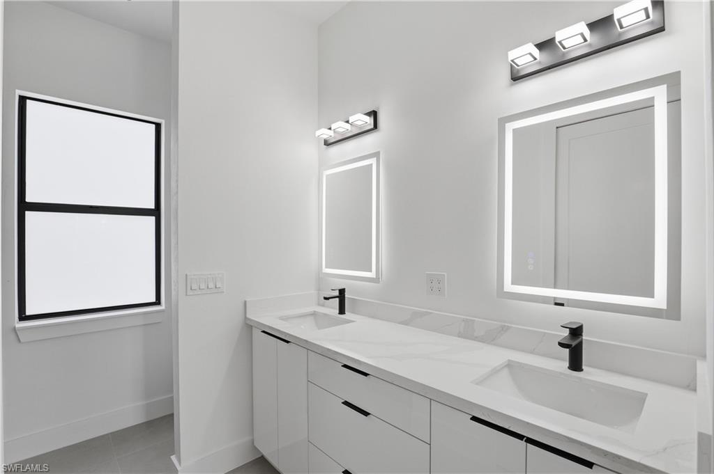 1122 Edelweiss Street East Lehigh Acres, FL 33974 - Photo 17 of 27 a bathroom with a sink and a mirror