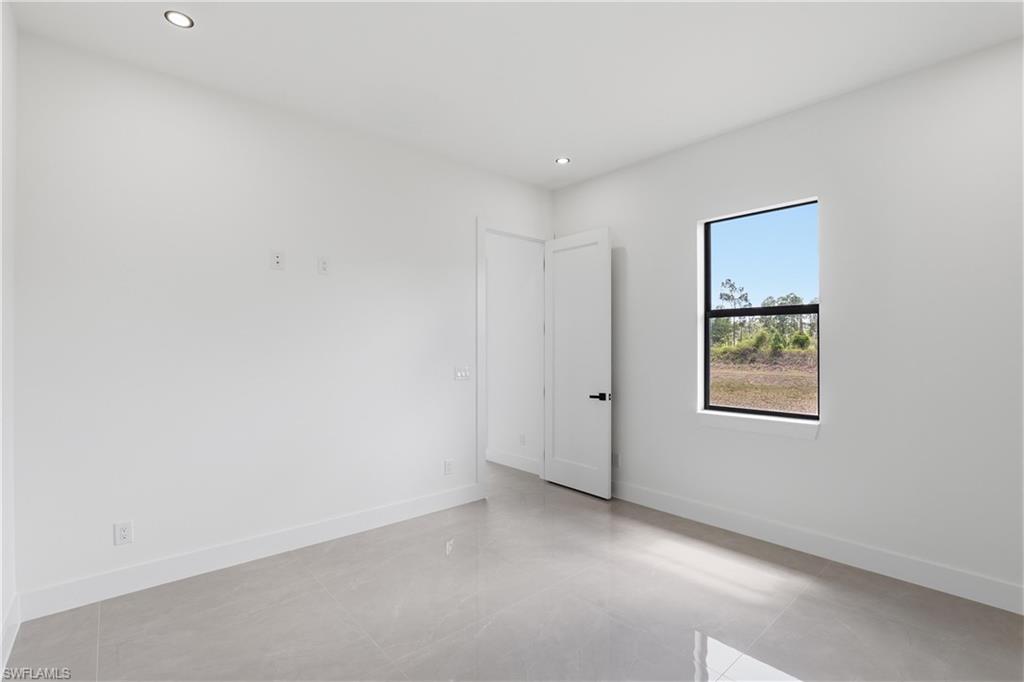 1122 Edelweiss Street East Lehigh Acres, FL 33974 - Photo 19 of 27 an empty room with windows
