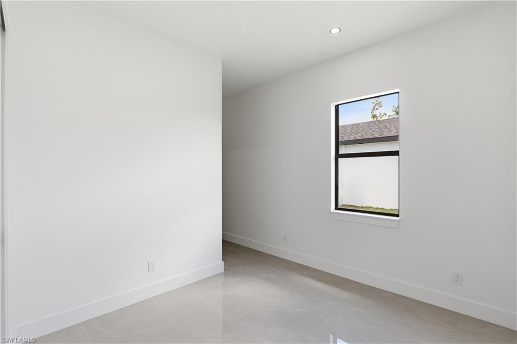 1122 Edelweiss Street East Lehigh Acres, FL 33974 - Photo 21 of 27 an empty room with windows