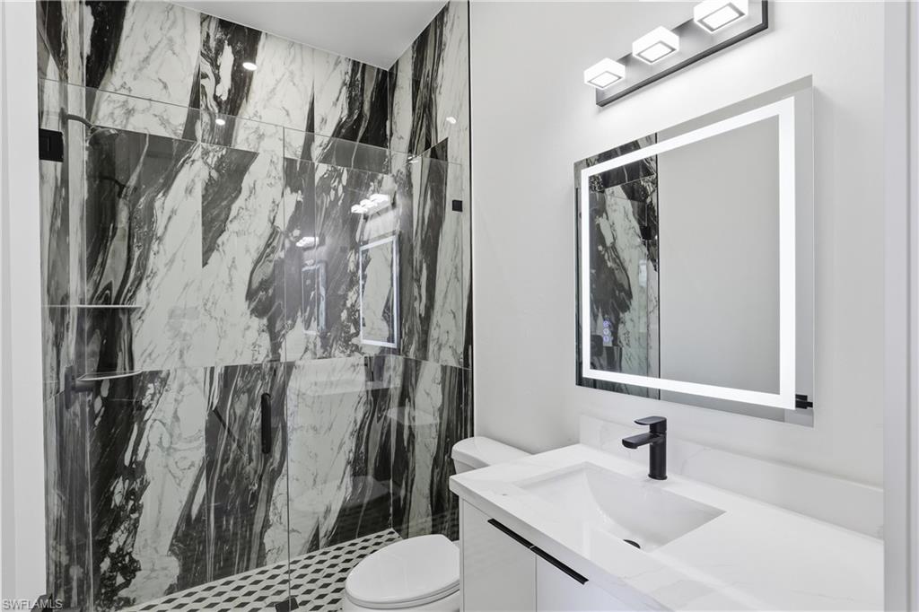 1122 Edelweiss Street East Lehigh Acres, FL 33974 - Photo 22 of 27 a bathroom with a sink toilet and shower
