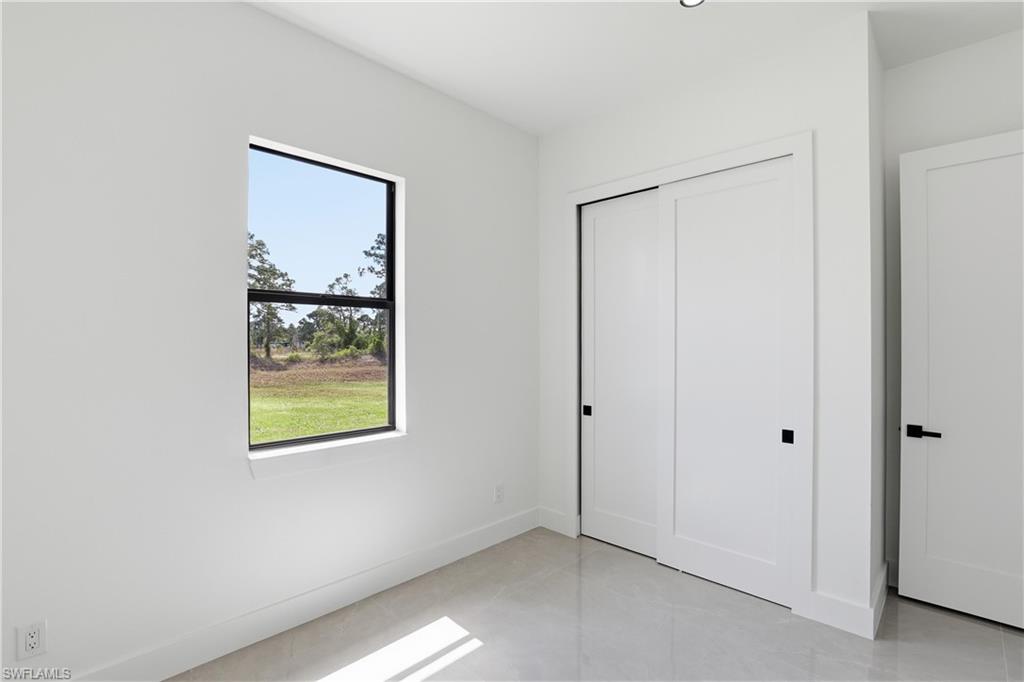 1122 Edelweiss Street East Lehigh Acres, FL 33974 - Photo 23 of 27 a view of an empty room with window and closet area