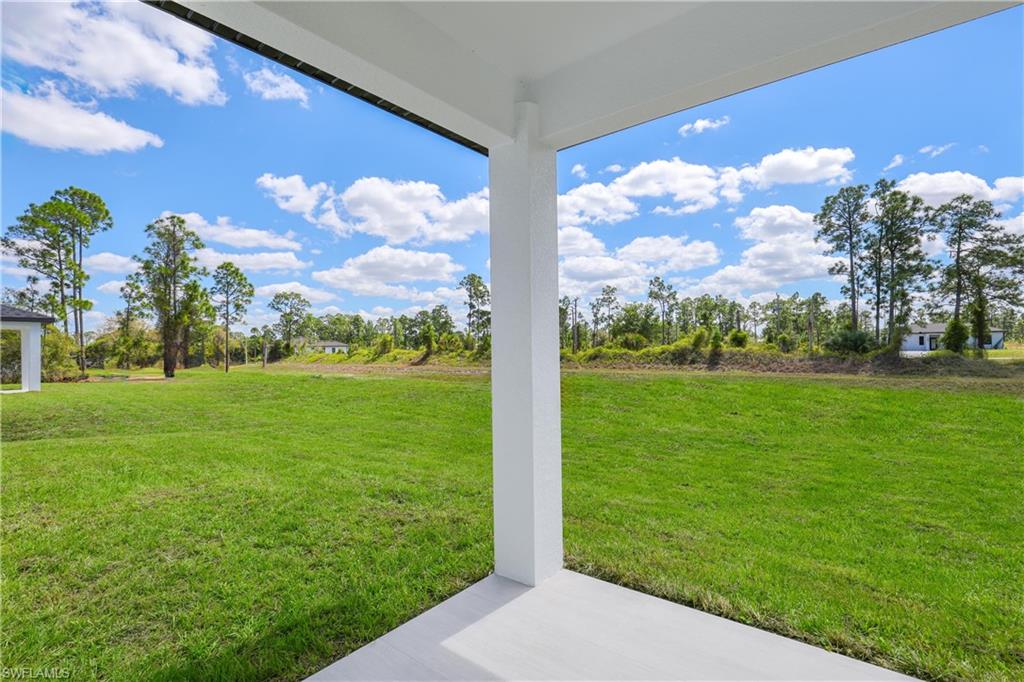 1122 Edelweiss Street East Lehigh Acres, FL 33974 - Photo 26 of 27 a view of a big yard with potted plants