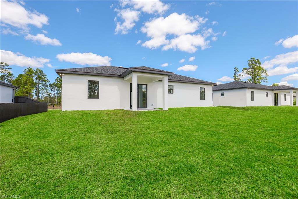 1122 Edelweiss Street East Lehigh Acres, FL 33974 - Photo 27 of 27 a view of white house with a yard