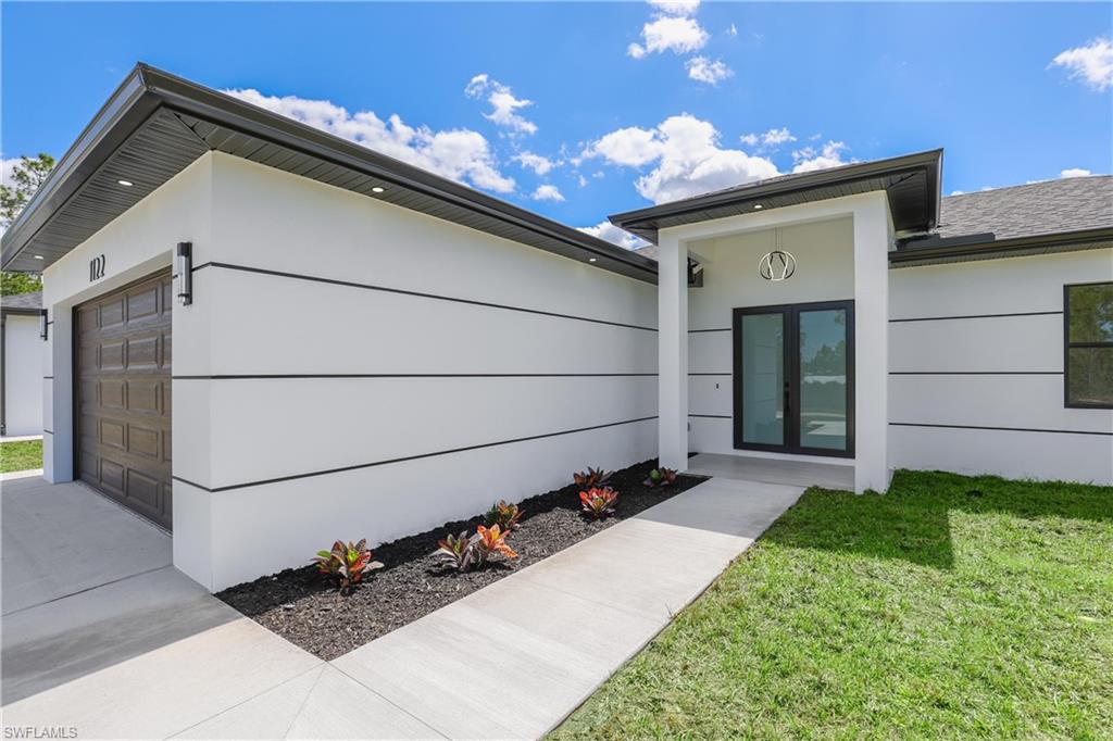 1122 Edelweiss Street East Lehigh Acres, FL 33974 - Photo 3 of 27 a house view with a backyard space