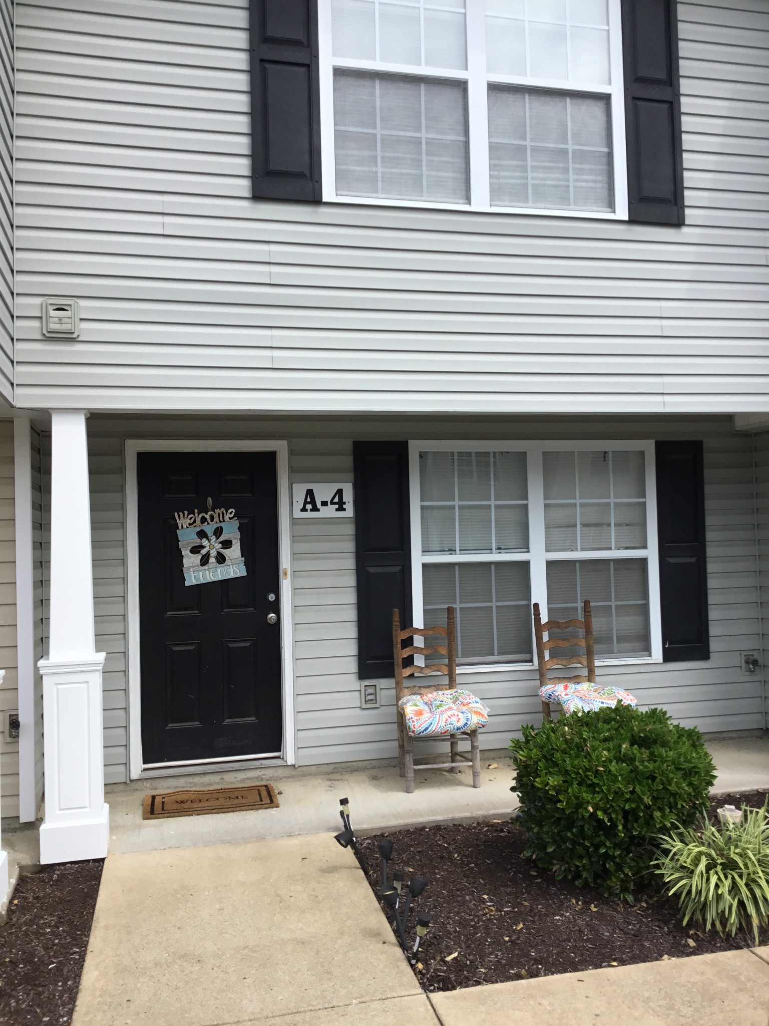 a front view of a house with sitting area