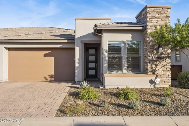 a dining room with furniture a chandelier and wooden floor