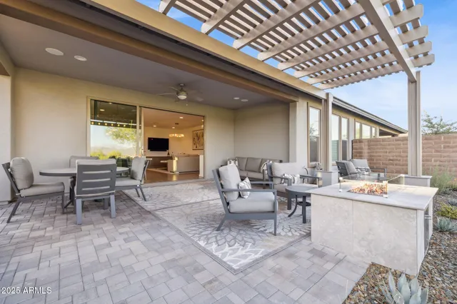 a view of swimming pool with outdoor seating and lake view
