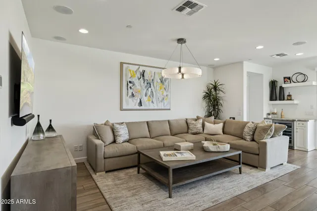 a spacious bedroom with a bed a couch and a flat screen tv