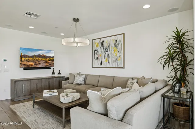 a en suite bathroom with a granite countertop sink and a mirror