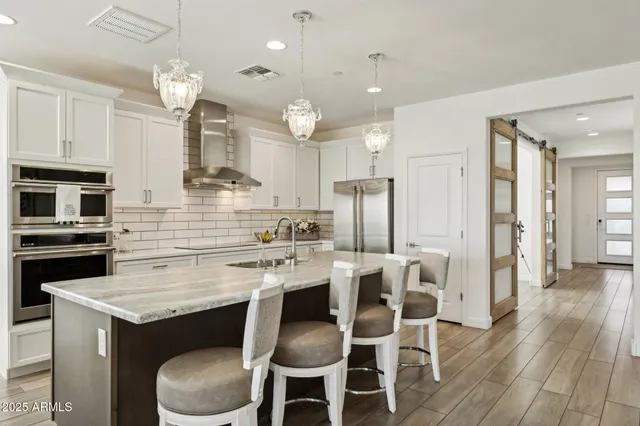 a bathroom with double sink and a mirror