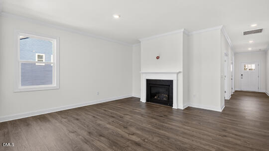 7580 Percussion Drive Apex, NC 27539 - Photo 18 of 44 an empty room with wooden floor and a fireplace