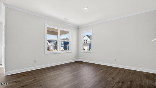 7580 Percussion Drive Apex, NC 27539 - Photo 20 of 44 an empty room with wooden floor and windows