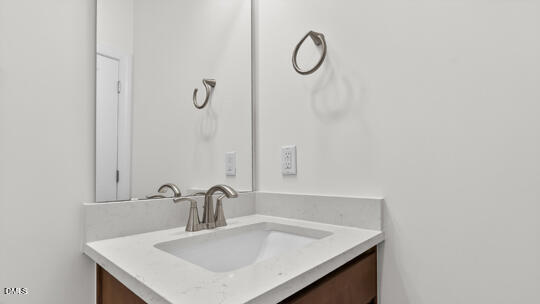 7580 Percussion Drive Apex, NC 27539 - Photo 35 of 44 a bathroom with a sink and a mirror