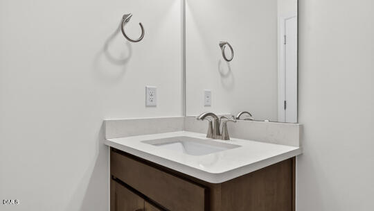 7580 Percussion Drive Apex, NC 27539 - Photo 36 of 44 a bathroom with a sink and mirror
