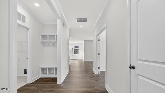 7580 Percussion Drive Apex, NC 27539 - Photo 4 of 44 a view of a hallway with wooden floor and staircase