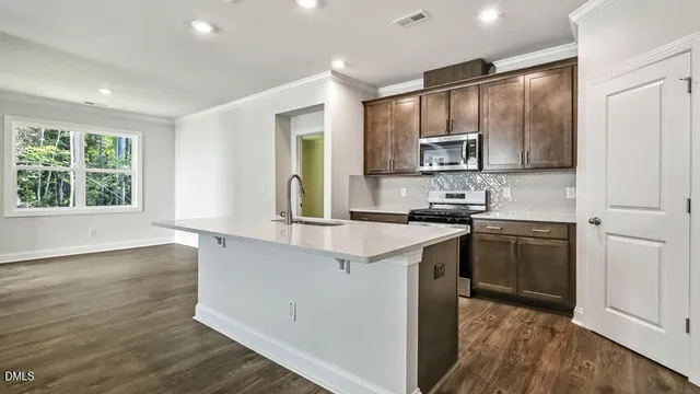 a kitchen with a sink stove and cabinets