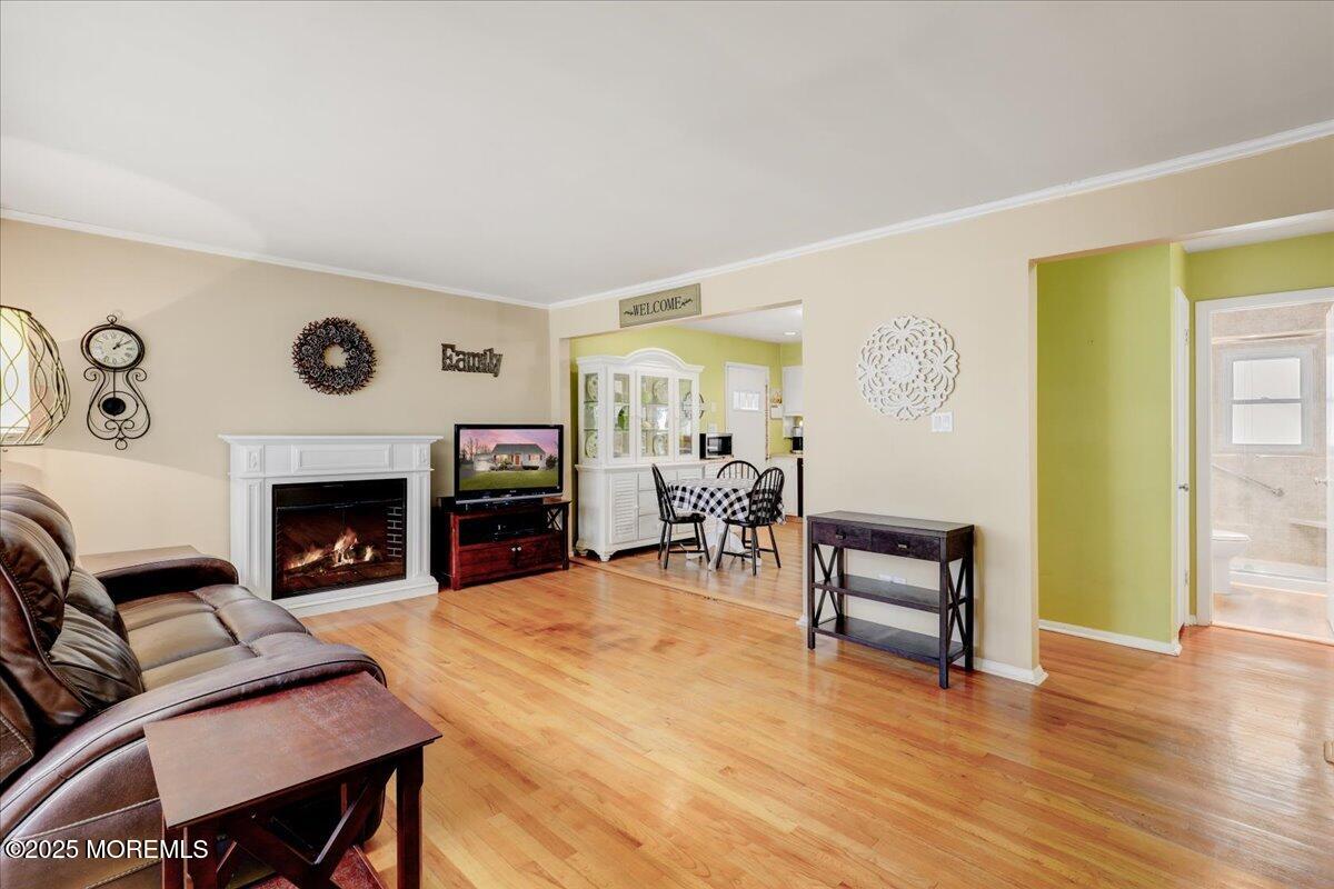 7 Rutgers Terrace Neptune Township, NJ 07753 - Photo 3 of 27 a living room with furniture a fireplace and a flat screen tv