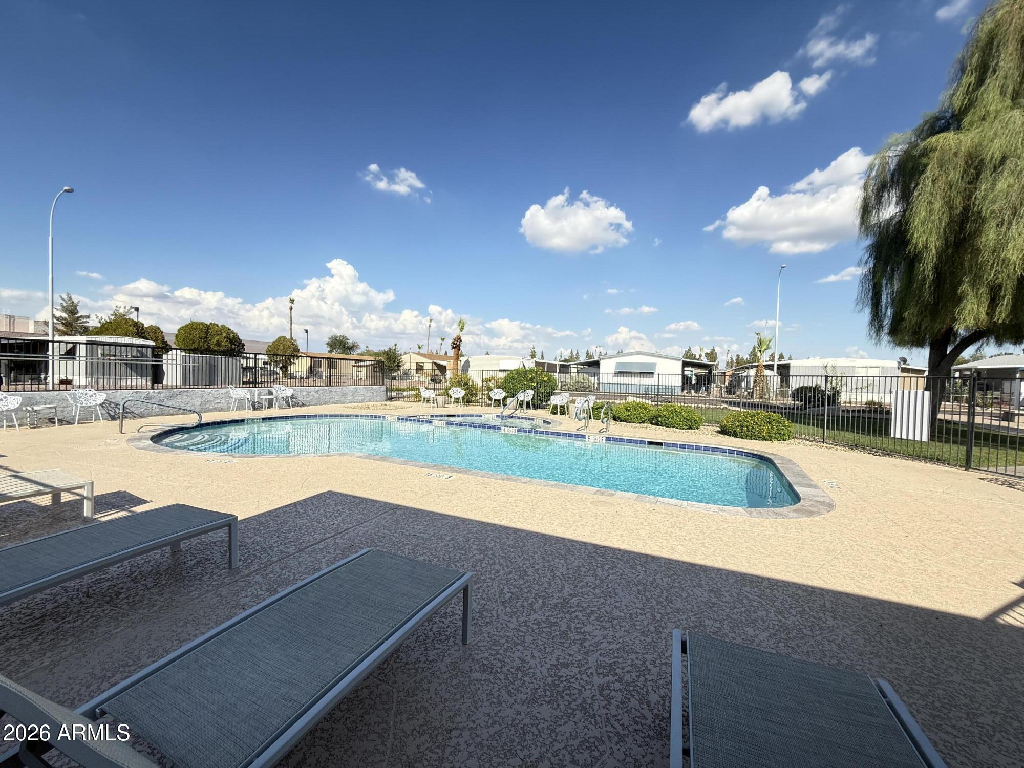 535 South Alma School Road, Unit 113 Mesa, AZ 85210 - Photo 23 of 41 a view of a swimming pool with an outdoor space and seating area