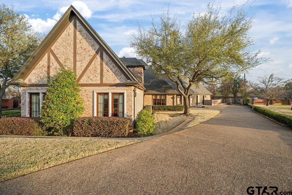 3048 Concord Place Tyler, TX 75701 - Photo 2 of 34 a front view of house with yard and trees around