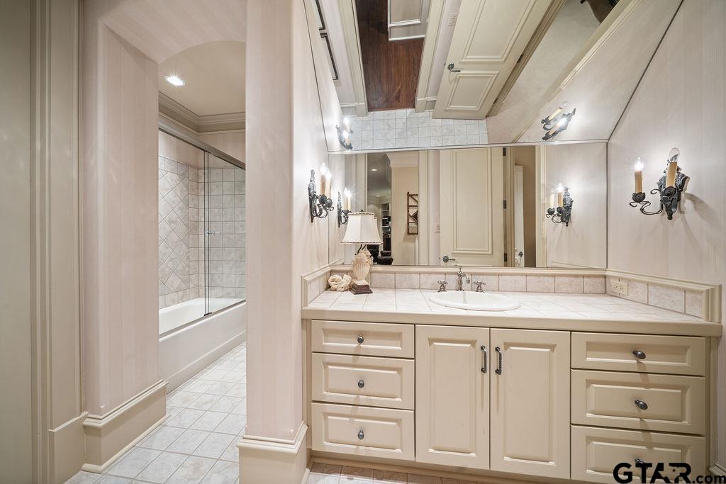 3048 Concord Place Tyler, TX 75701 - Photo 24 of 34 a bathroom with a granite countertop sink a mirror and a