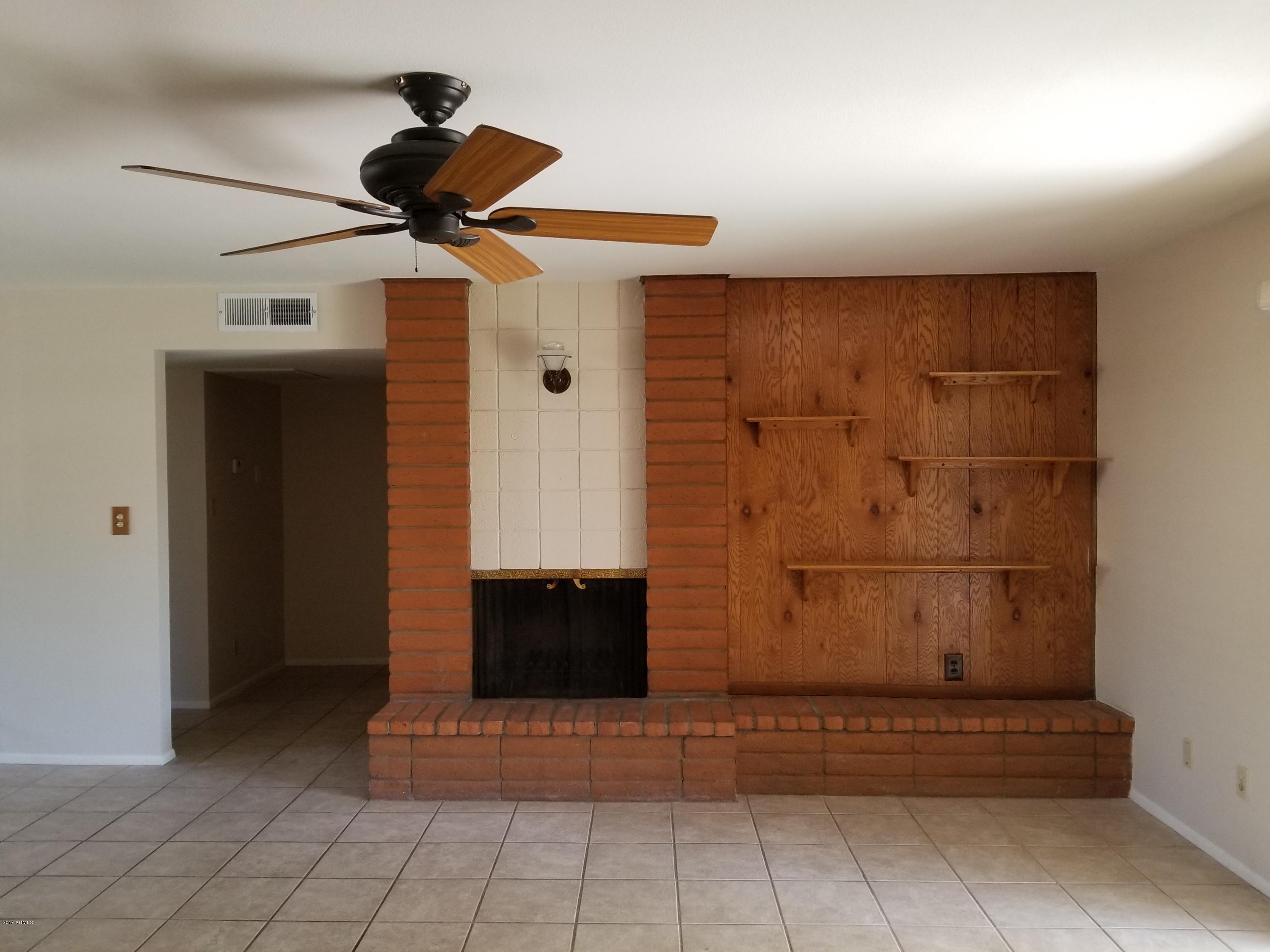 4221 West Redfield Road Phoenix, AZ 85053 - Photo 15 of 16 Livingroom with fireplace