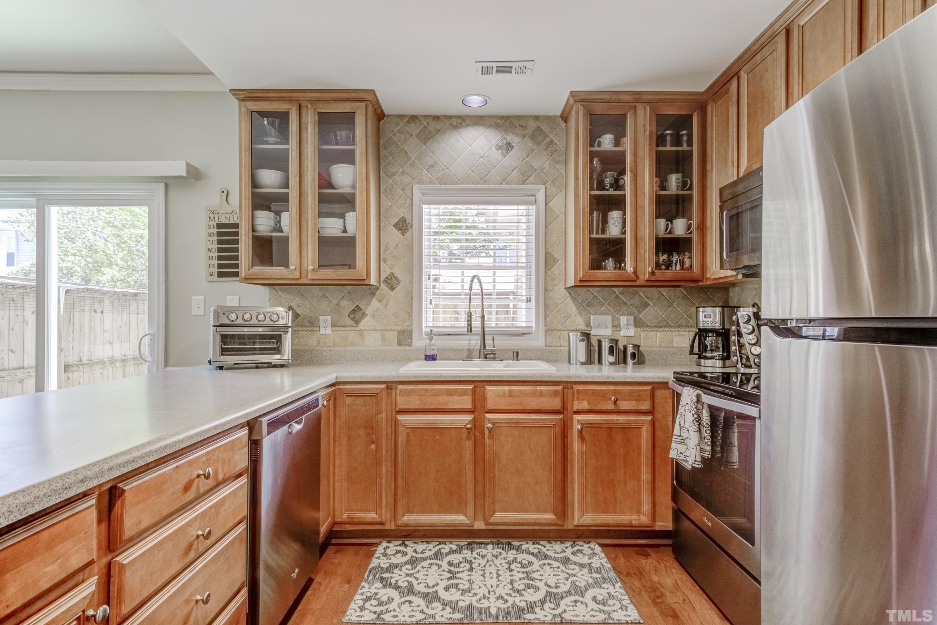2101 Piney Brook Road, Unit 107 Raleigh, NC 27614 - Photo 17 of 37 a kitchen with stainless steel appliances granite countertop a refrigerator and a sink