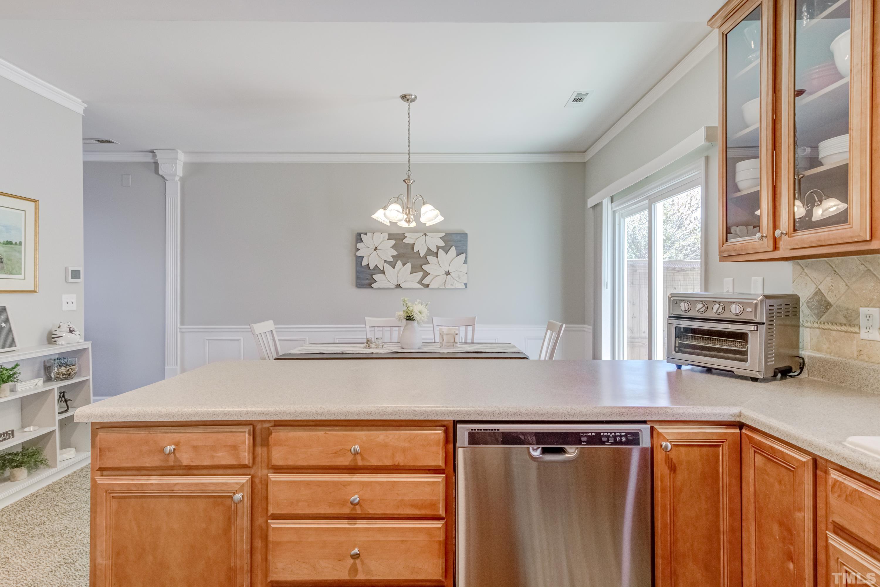 2101 Piney Brook Road, Unit 107 Raleigh, NC 27614 - Photo 18 of 37 a view of kitchen with stainless steel appliances granite countertop a sink window and cabinets
