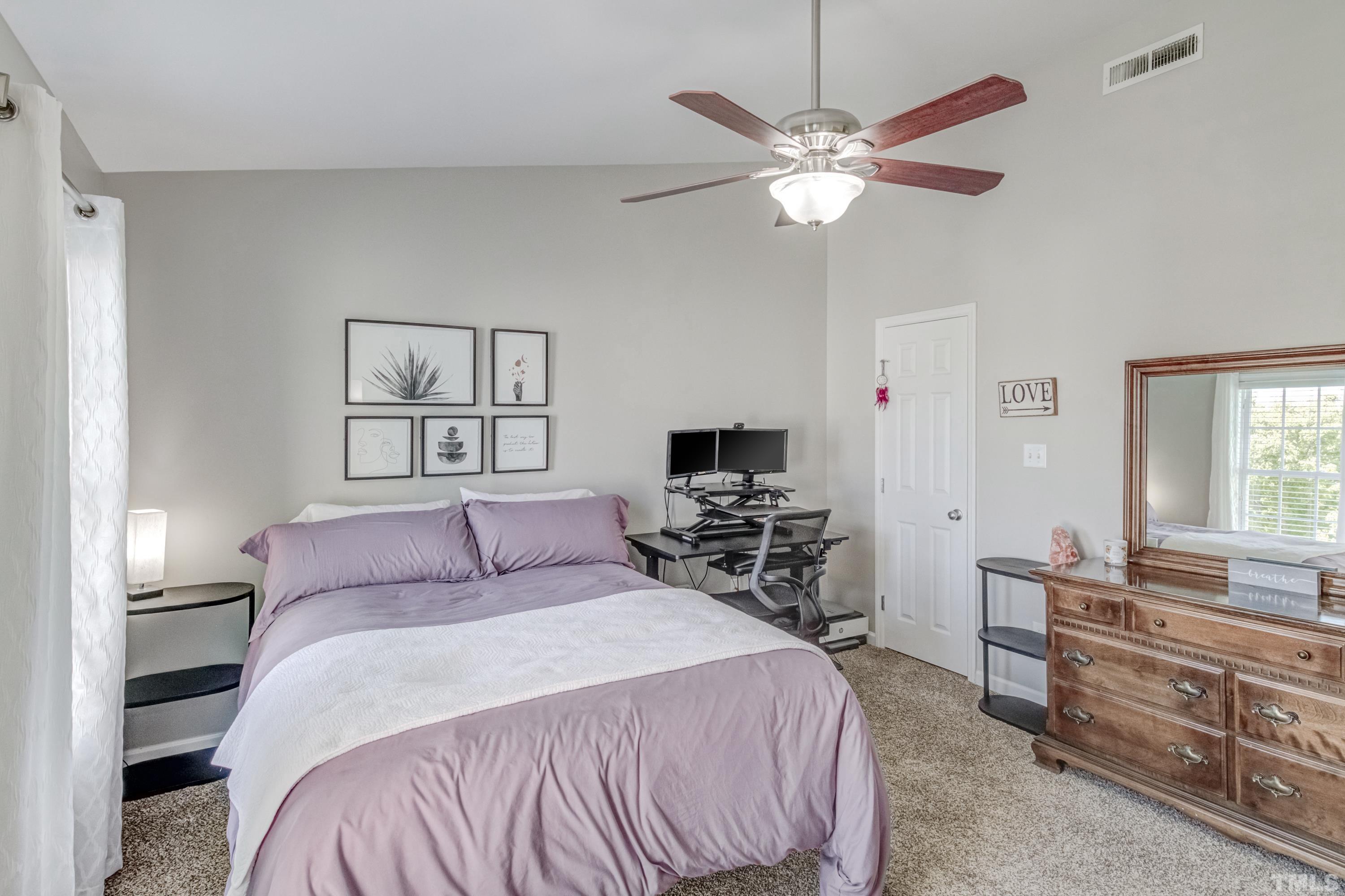 2101 Piney Brook Road, Unit 107 Raleigh, NC 27614 - Photo 23 of 37 a bedroom with a large bed and a chandelier