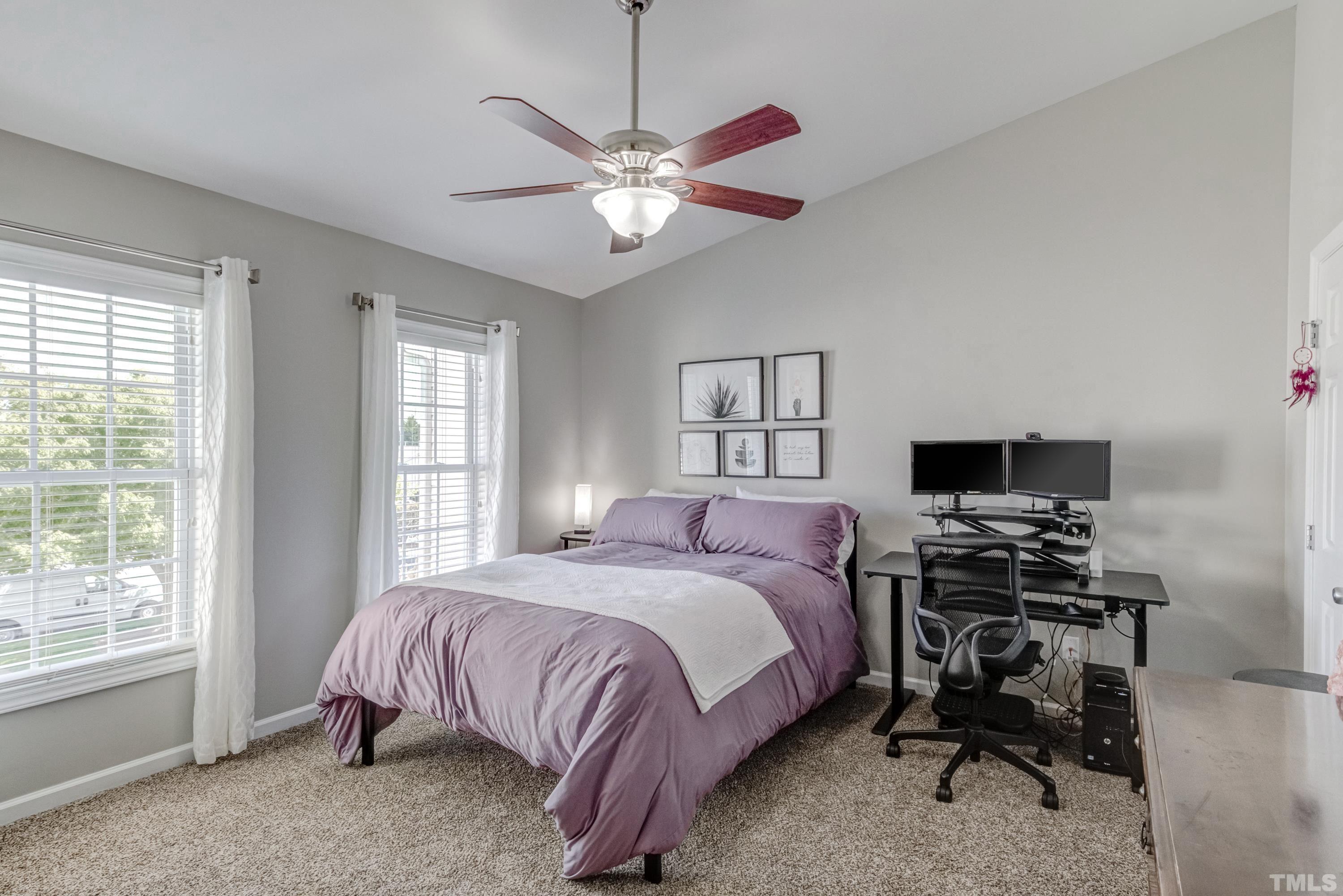 2101 Piney Brook Road, Unit 107 Raleigh, NC 27614 - Photo 24 of 37 a bedroom with a bed and a chandelier